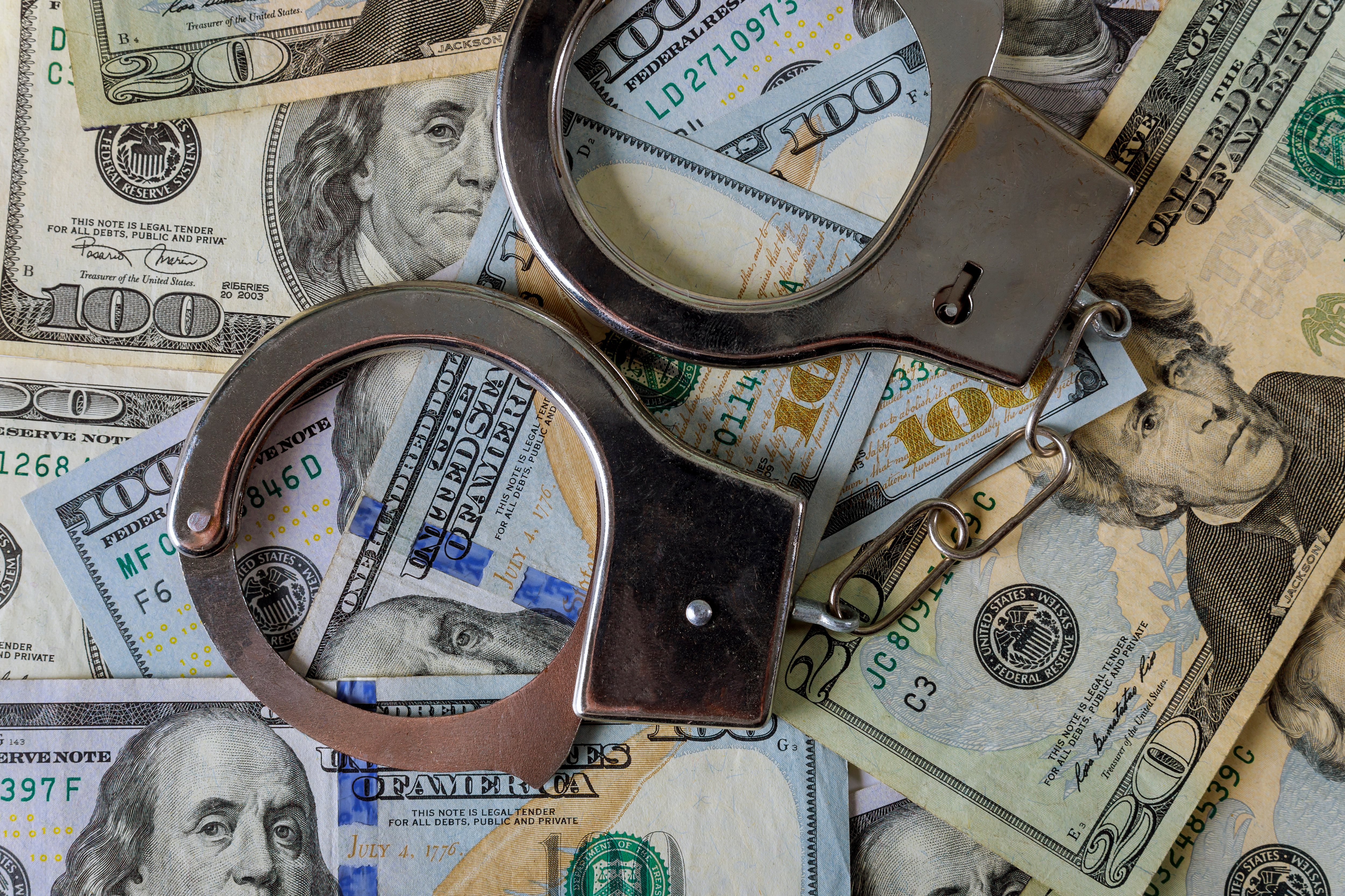 An image of money and handcuffs