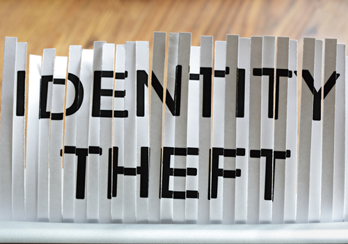 Shredded piece of paper with the words identity theft on it.