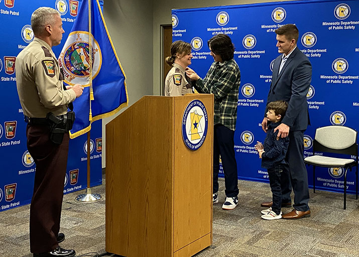 Lt. Col. Christina Bogojevic during her promotion ceremony with her family and Col. Matt Langer looking on