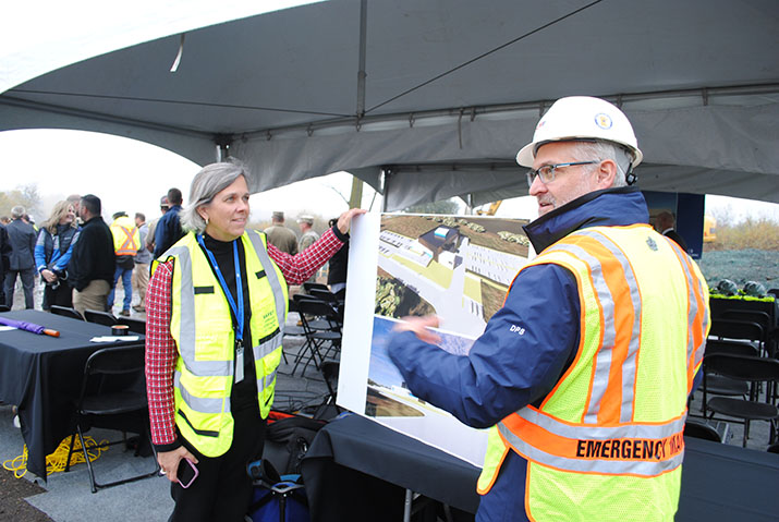 HSEM Director Kristi Rollwagen and Deputy Director Kevin Reed looking at renderings while visiting the site for a groundbreaking event.