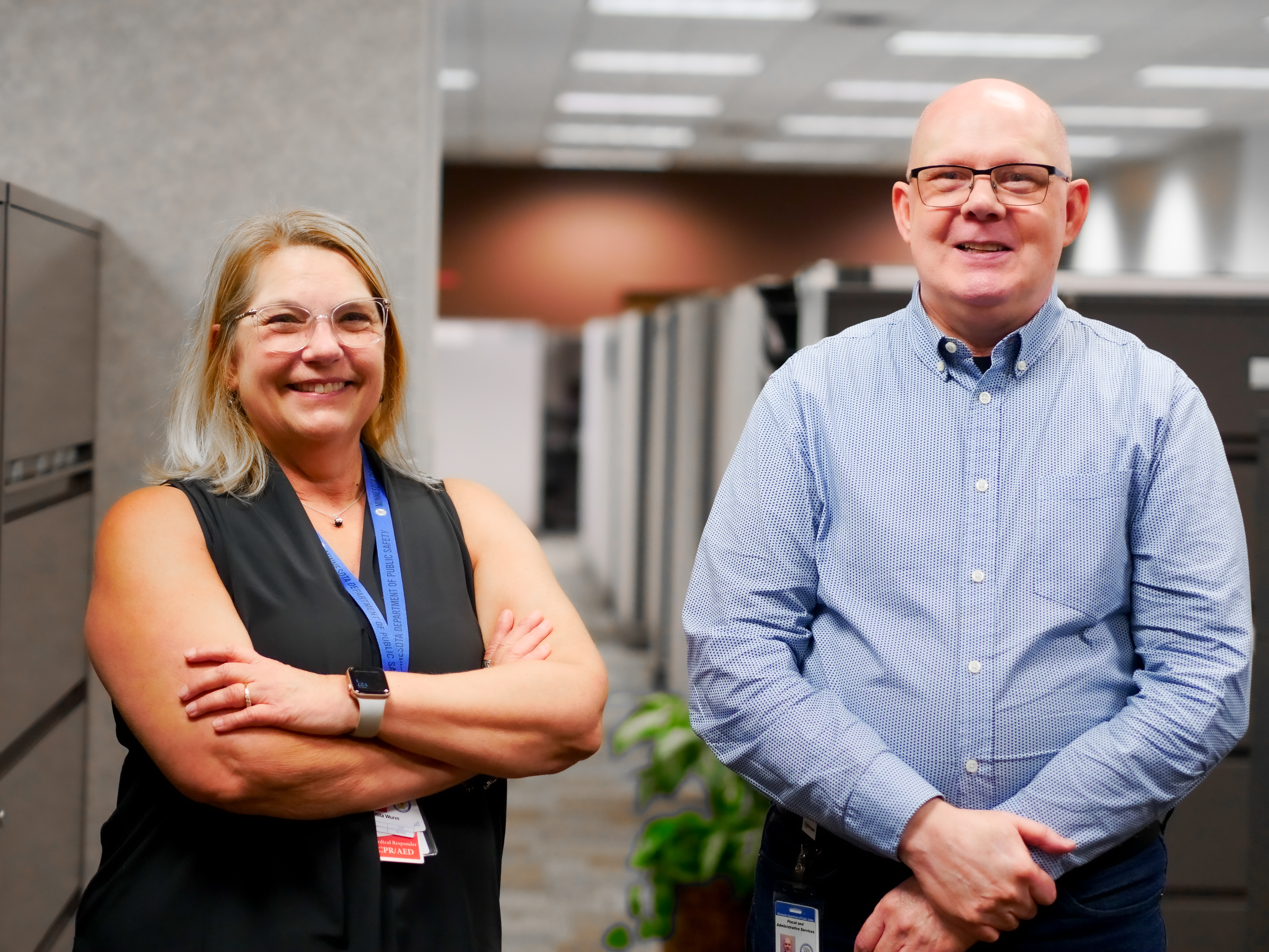 Two FAS staff members smile in the DPS office