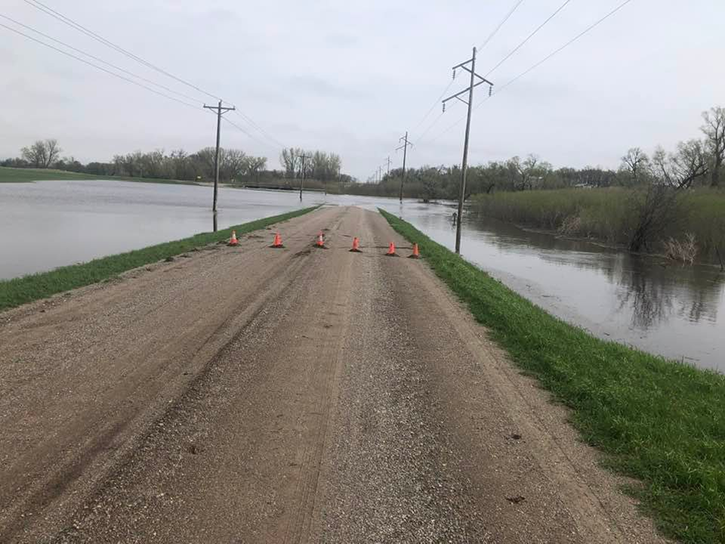 Floodwaters cover a road in rural Minnesota