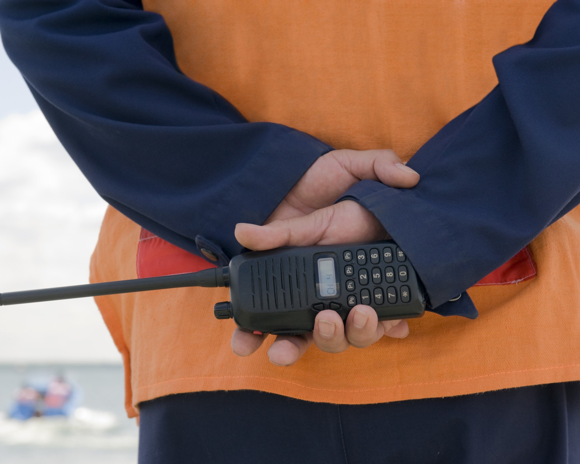 First responder holding a radio behind their back