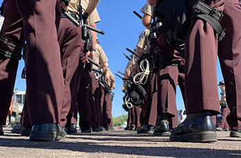 The legs of Mobile Response Team members as they stand in a two-column formation