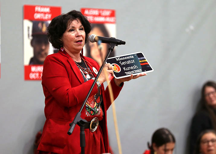 Sen. Kunesh holds up special license plate