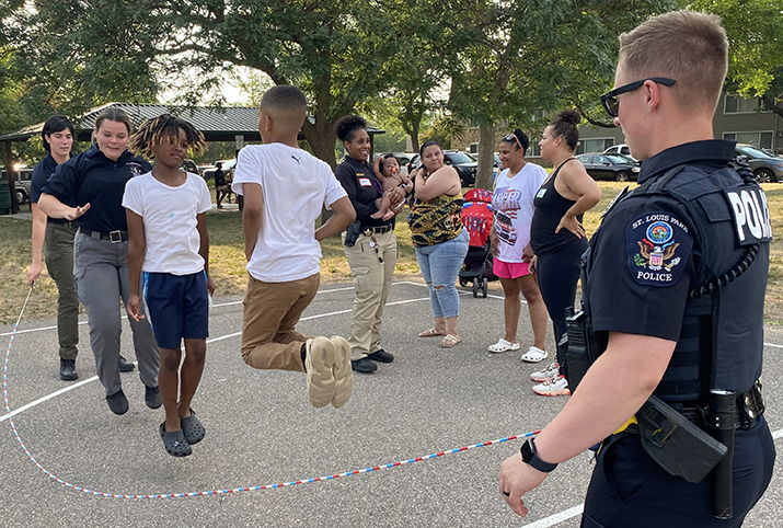 Police officers jump rope with kids