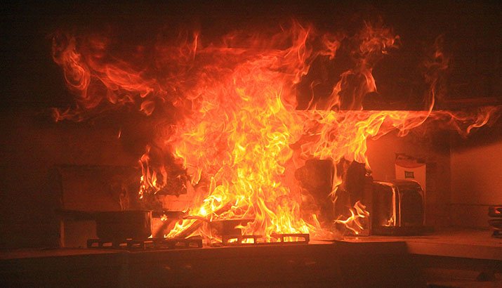 A grease fire gets out of control on a stove. 